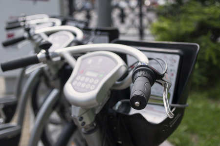 Exercise bikes in a row, standing outdoors, concept of healthy lifestyle, shallow depth of field