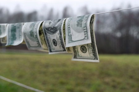 Hundreds of US dollars banknotes drying on the string, outdoor shot with particular focus