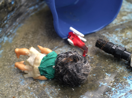 Abandoned toys laid on a floor after a flood, closeup outdoor shot. Concept of natural disasterの写真素材