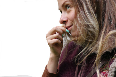 Side cropped shot of a young woman with a curious look on her face, selective focus shot, isolated on whiteの写真素材