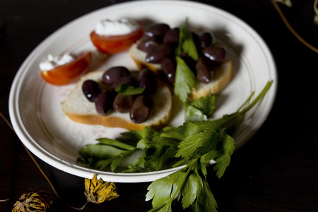Parsley and garnish with olives laid on the plate, closeup angled shotの写真素材