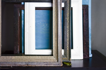 Various old wooden picture frames laid on a table in the artist studio, closeup cropped shotの写真素材