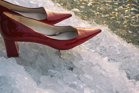 Red high heels on the ice and snow, particular focus filtered shotの写真素材
