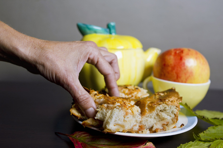 Female hand taking a piece of home made cale laud on a table, studio selective focus shotの写真素材