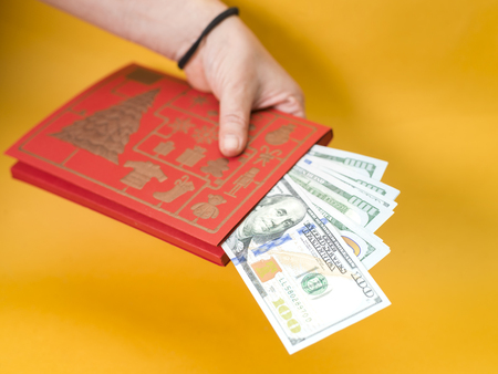 Female hand with a bunch of cash, selective focus studio shotの写真素材