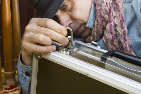 Male, seems like a thief opening a briefcase, closeup cropped shotの写真素材