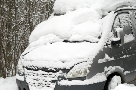Abandoned bus trapped in snow, outdoor cropped photoの写真素材