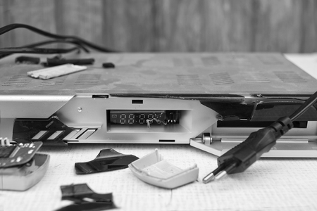 Crashed CD player or  satellite receiver closeup. In black and whiteの写真素材