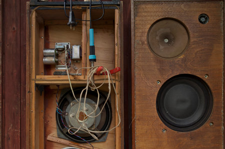 Damaged vintage loudspeakers repair, wooden wall in the backgroundの写真素材