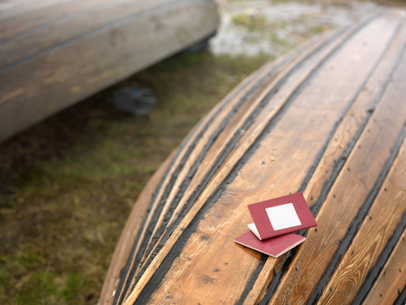 Twp passports laid on the capsized boat, selective focus photoの写真素材