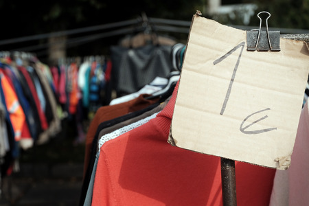 One euro price tag attached to the clothes hanging on the hangersの写真素材