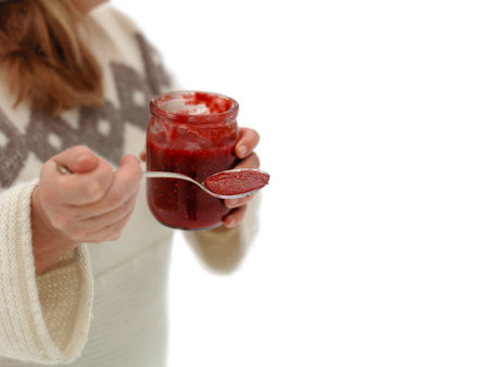 Isolated on white shot of a woman with spoon and jam