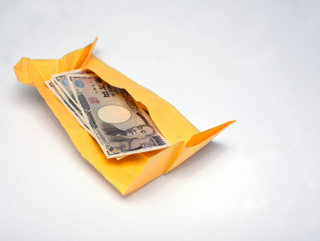 Japanese yen wrapped in a paper, closeup studio shotの写真素材