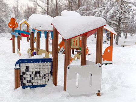 A children playground in a park covered with massive snowの写真素材