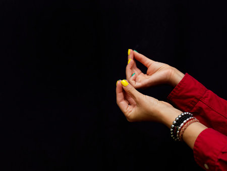 Female hands gesturing while discussion, studio shot on black