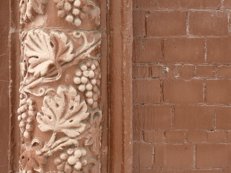 Stucco brick wall closeup with decorative ornamentの写真素材