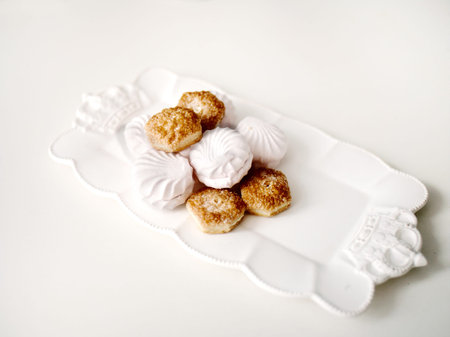 Closeup of the biscuits and pastry on a white table topの写真素材
