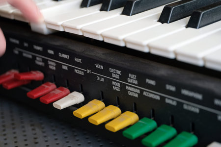 Blurred motion shot of a human hand playing vintage keyboard with colourful switches