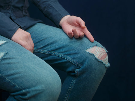 Woman sitting in ripped jeans and gesturing