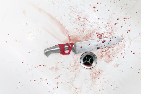 Leaking blood into a bath drain and a knife, above view, concept of criminal and violenceの写真素材