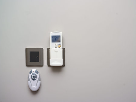 Various remote controls hanging on the wall, indoor closeup