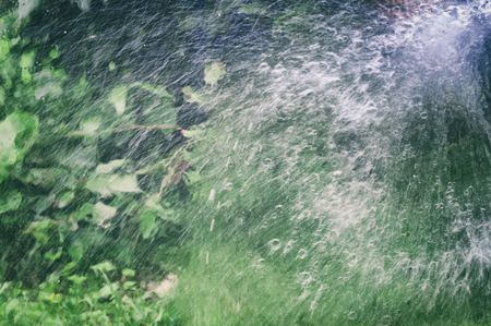 Blurred motion filtered shot of water and splashed  in a gardenの写真素材