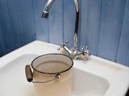 Empty can in a kitchen sink, indoor closeupの写真素材