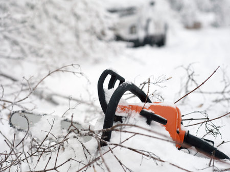 Blocked road with fallen tree and a chainsaw in the foregroundの写真素材