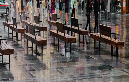 Cropped shot of people walking under rain on the streetの写真素材