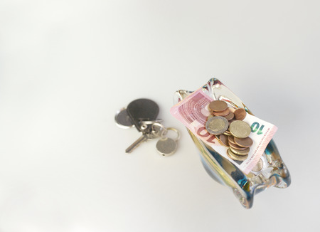 A copy space still of a small vase full of euro coins and few banknotes, studio shotの写真素材