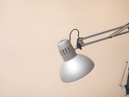Close-up of expandable electric lamp against the wall