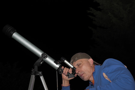Amateur astronomist with children telescope, night sceneの写真素材
