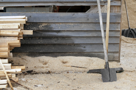 A stack of timber, sawdust and shovels in a sawmill, otdoor shotの写真素材