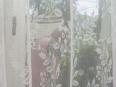 Closeup of a semi-transparent curtain on windowの写真素材