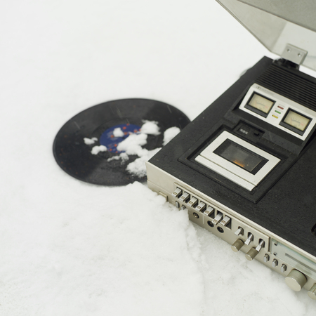 Retro stereo player and vinyl placed on the snow, outdoor square imageの写真素材