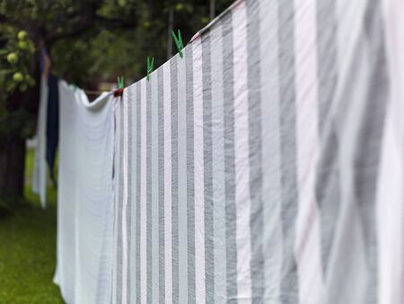 Ckean laundry pinned on a rope outdoor, shallow depth of fieldの写真素材