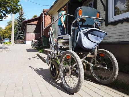 A wheelchair abandoned on the street, outdoor shotの写真素材