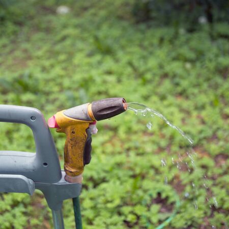 clpseup of a portable watering cart with water leaking from hose