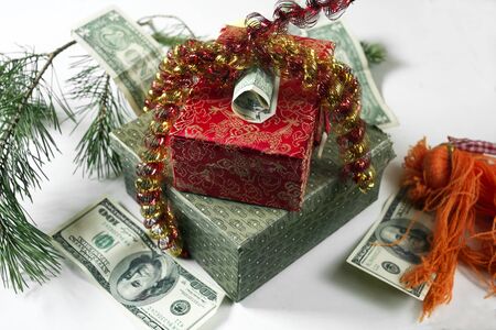 American dollars and  colorful gift boxes wrapped with tinsel, studio close-upの写真素材