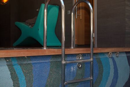 Steel ladder of indoor swimmimg pool, night sceneの写真素材