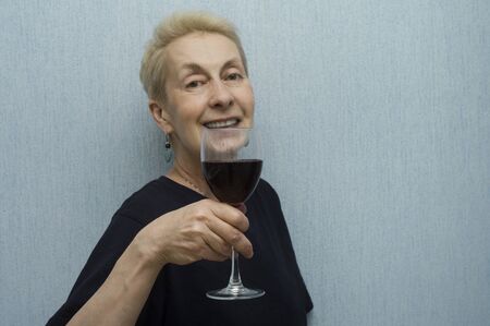 Studio portrait of a woman  in t-shirt holding wineglass の写真素材