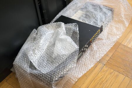 Musical rack mount equioment wrapped in cellophane foil, indoor close-up