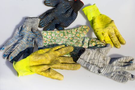 Collection of used and dirty protective work gloves, outdoor shotの写真素材