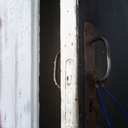 Open door with a cable lock hanging on a handle