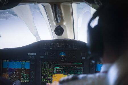 Frozen plane windshield and a pilot in the blurred foregroundの写真素材