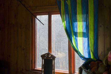 A room with damage curtain holder hanging next to windowの写真素材