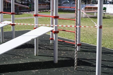 Outdoor sport playground blocked with warning tape, city scene