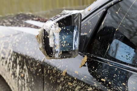 Broken mirror of a dirty vehicle, outdoor close-up shotの写真素材