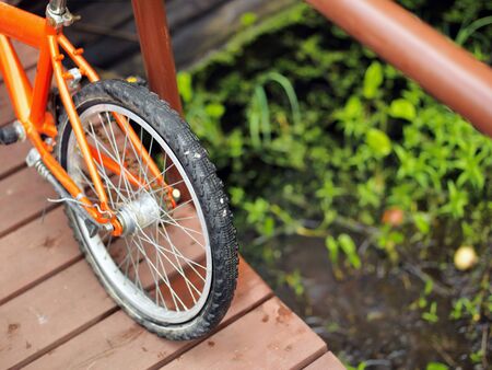 Bicycle on a wooden bridge across a river or bog, outdoor cropped shot