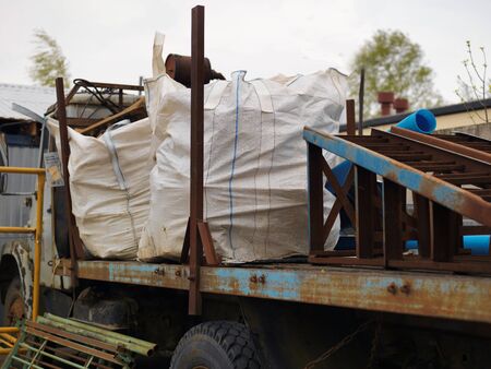 Abandoned old track loaded with discarded construction stuffの写真素材